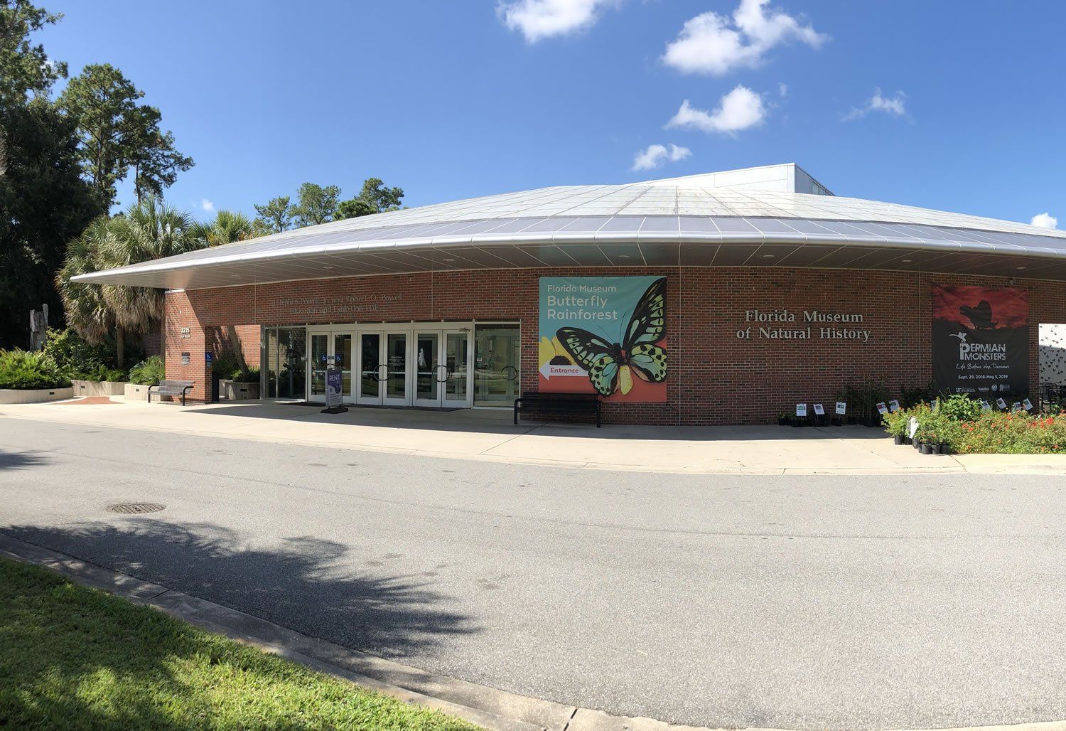 Brick building with a circular roof, a sign reading 