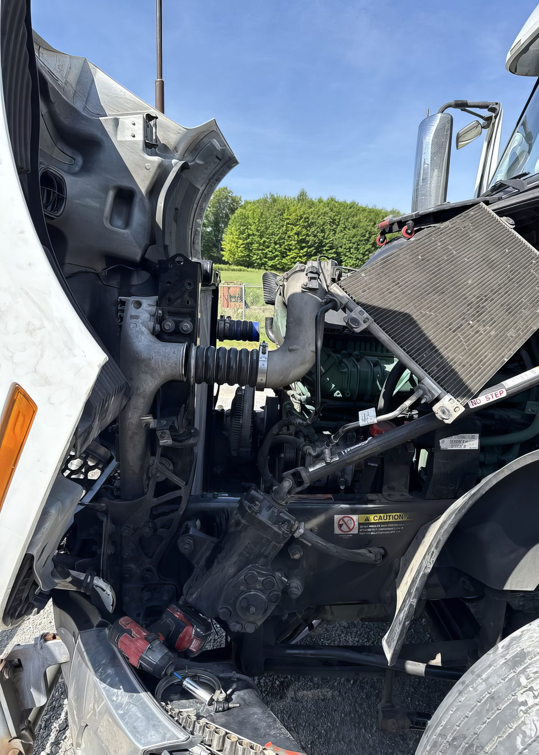 Severely damaged truck cab with crushed metal and debris after a crash