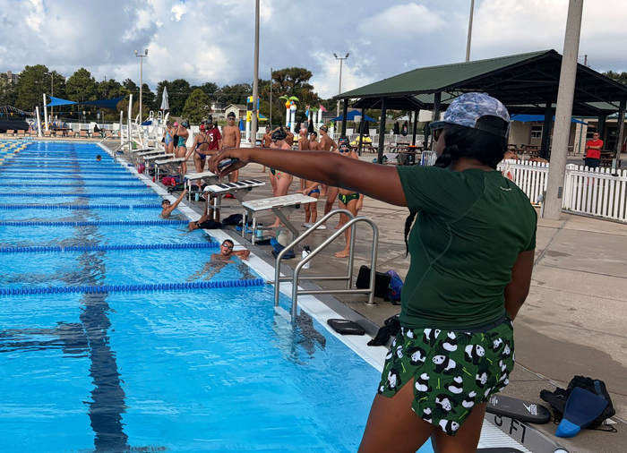 Coach with swimmers