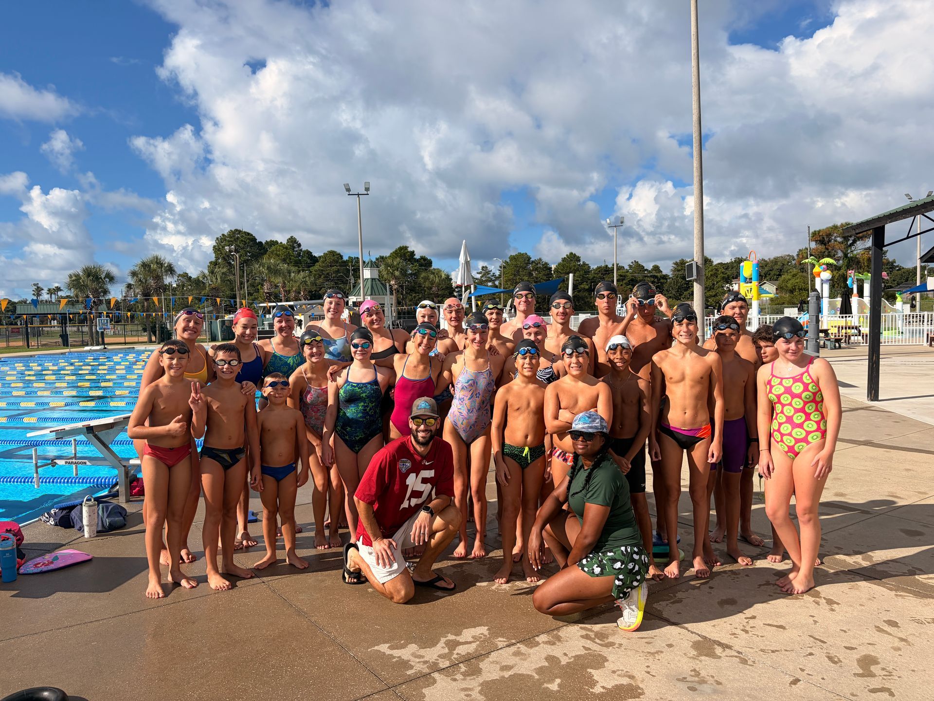 Group of swimmers with Coach Scott at his last practice