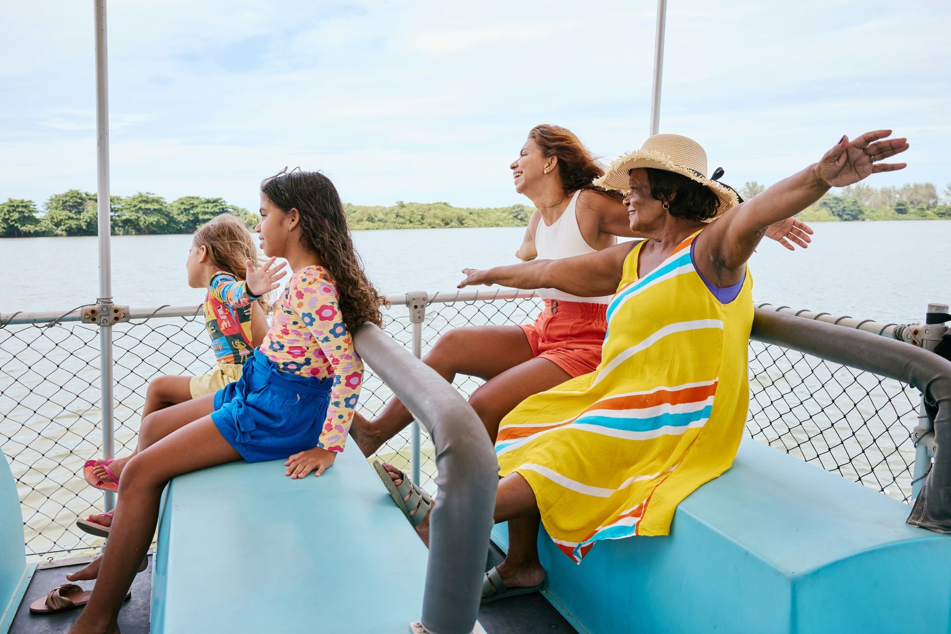 A group of people are sitting on a boat in the water.