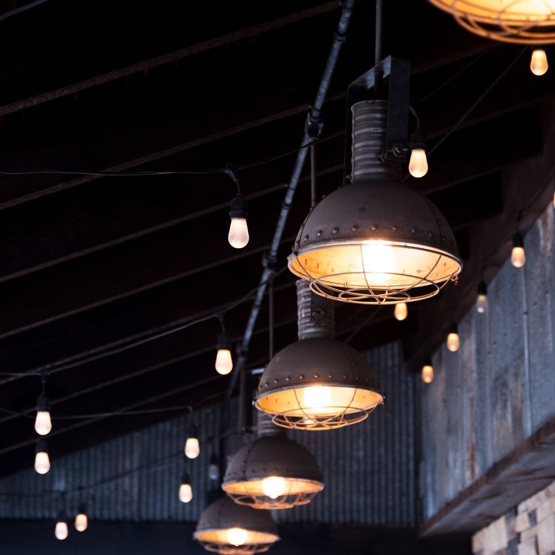 A row of lights hanging from the ceiling in a dark room