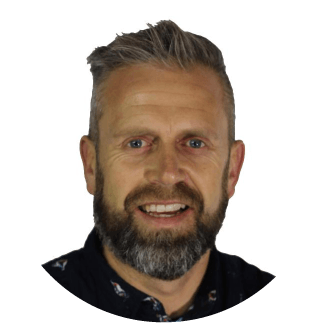 a man with a beard is smiling for the camera