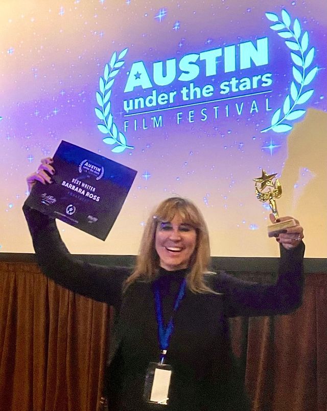 Barbara J. Ross holding the Best Writer award at Austin Film Festival Under the Stars