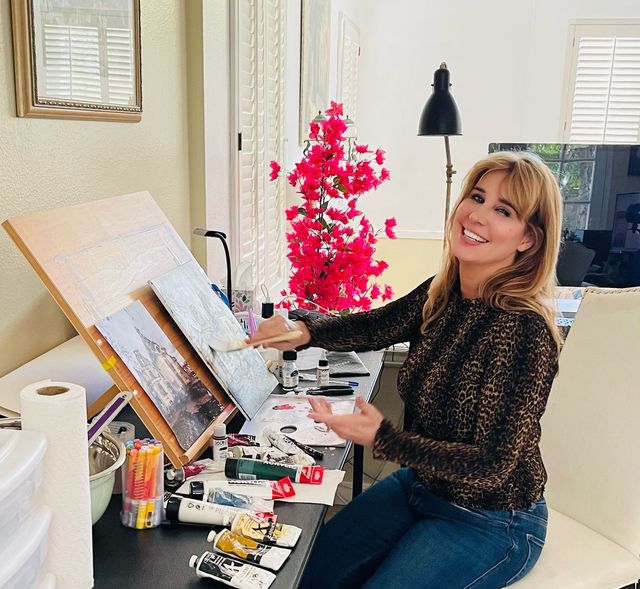 Barbara J. Ross painting at her desk