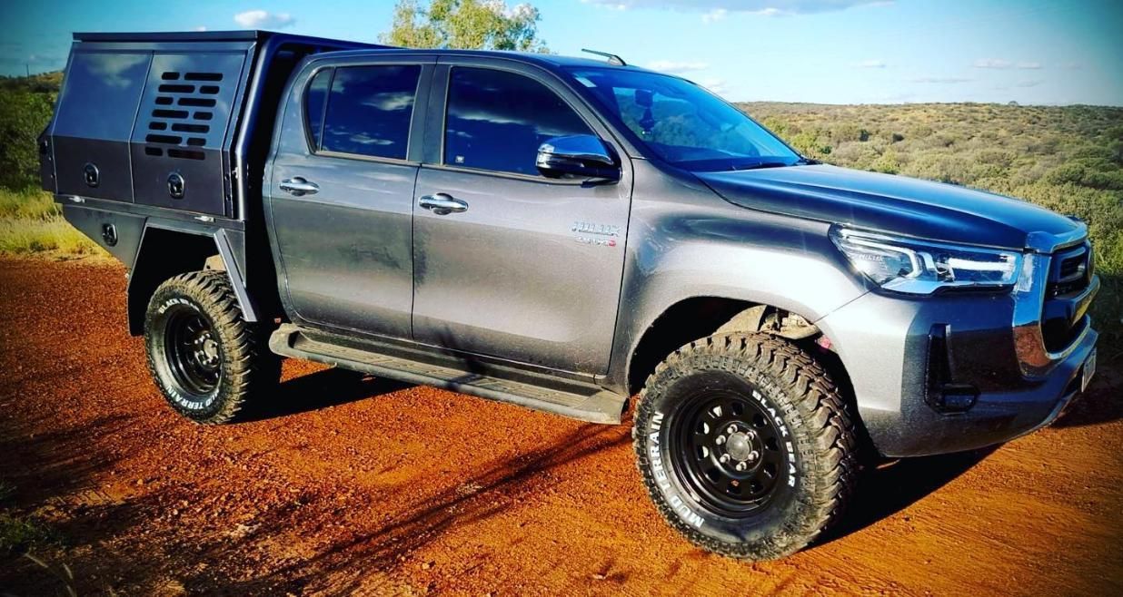 A Toyota Hilux Pickup Truck Is Parked On A Dirt Road — Territory Wrecking Repairs In Alice Springs, NT