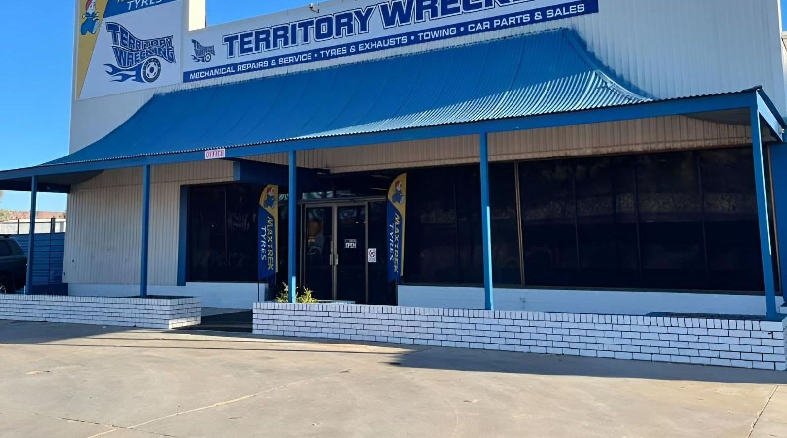 A Building With A Blue Awning And A Sign That Says `` Territory Wheel '' — Territory Wrecking Repairs In Alice Springs, NT
