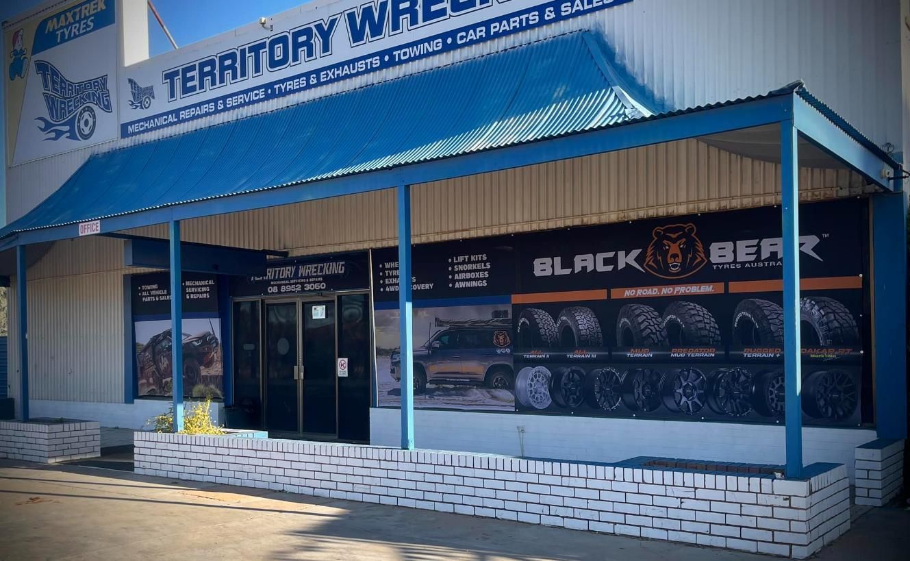 A Store Front With A Blue Awning — Territory Wrecking Repairs In Alice Springs, NT