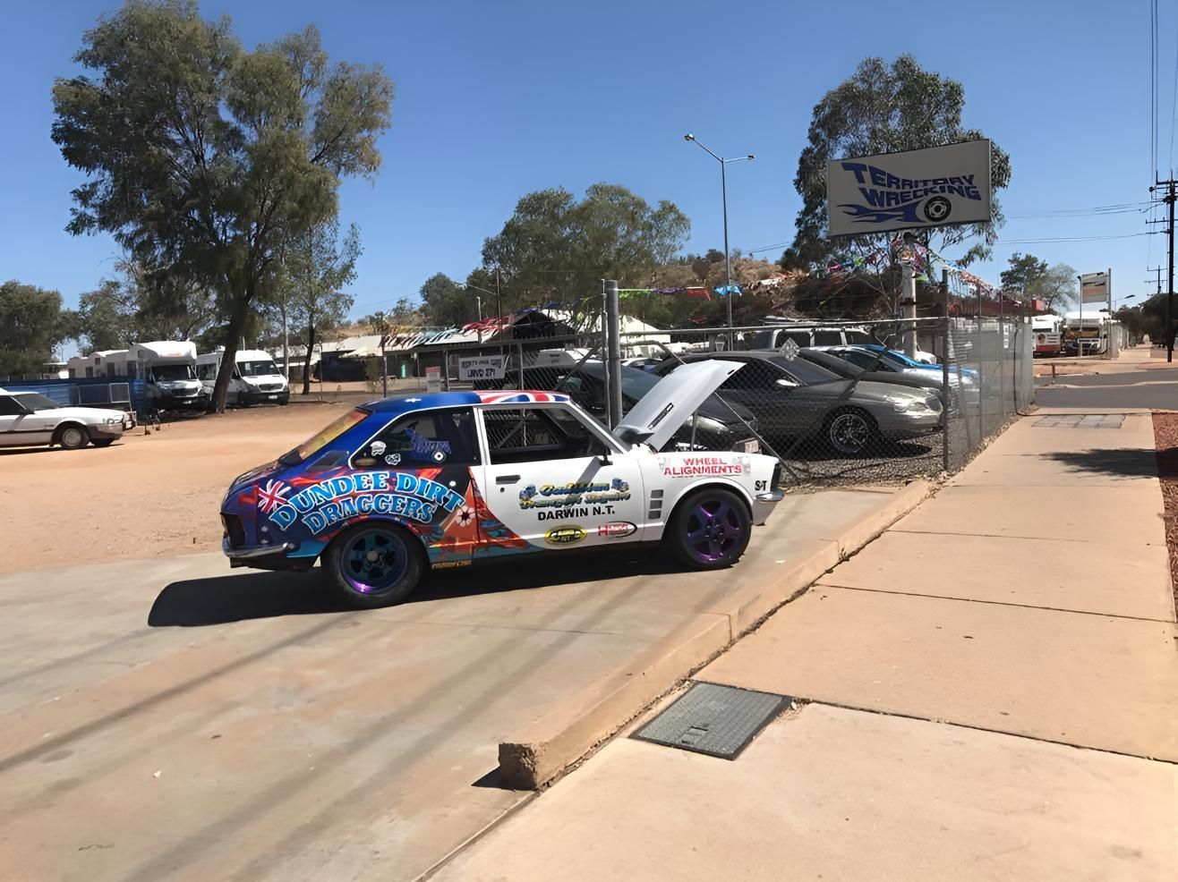 A Blue And White Car Is Parked On The Side Of The Road — Territory Wrecking Repairs In Alice Springs, NT