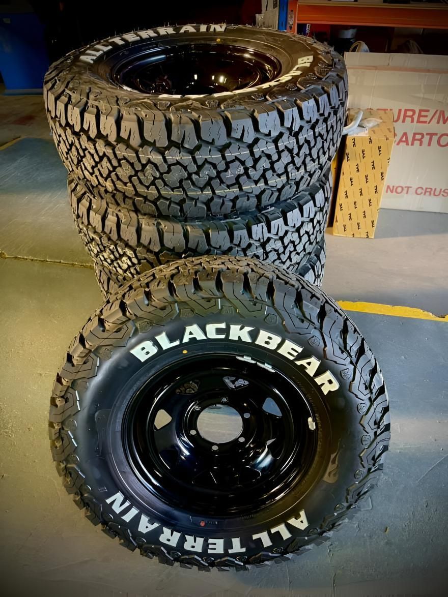 A Stack Of Black Bear All Terrain Tires Sitting On Top Of Each Other — Territory Wrecking Repairs In Alice Springs, NT