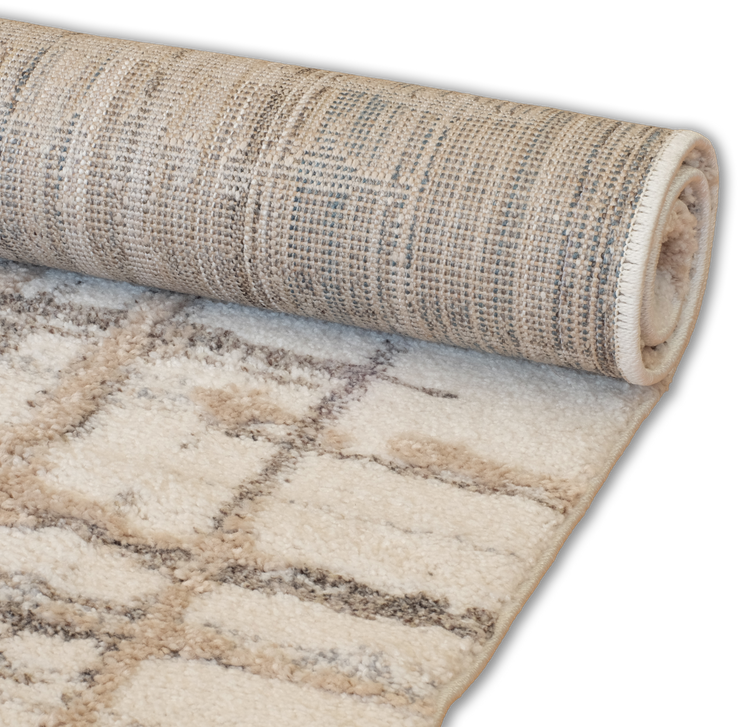 Rolled-up beige rug with a patterned surface. 