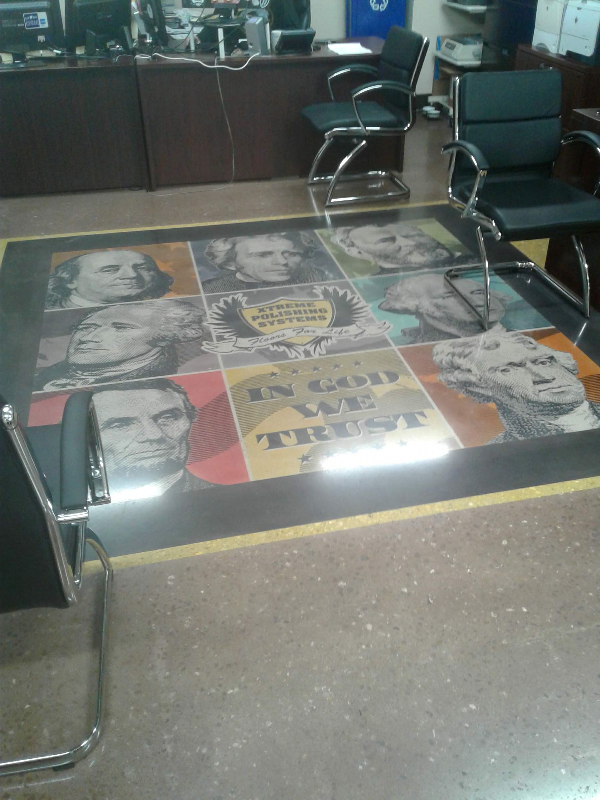 Salon chair facing a glass coffee table with colorful pop-art faces and a tiled floor nearby