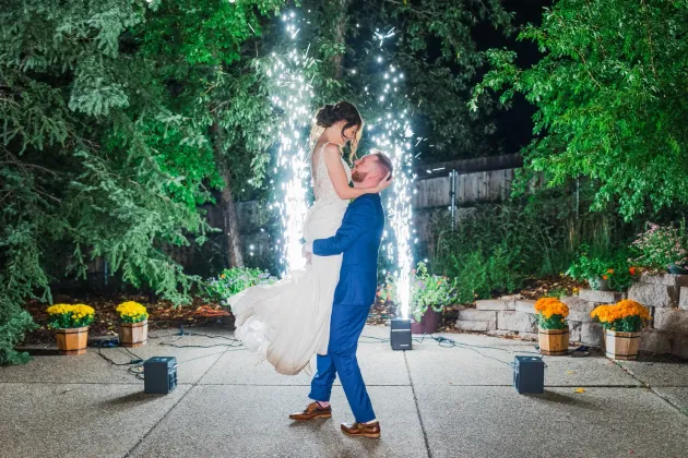 A bride and groom are dancing in front of a fireworks display at the Gardens at Viola's in Flagstaff.