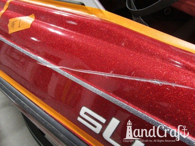 Skeeter boat with deep scratch running through multiple colors of metal flake