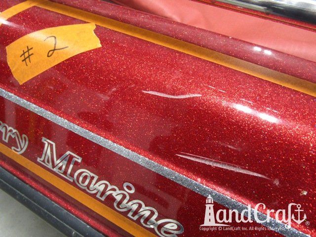 Skeeter boat with deep scratch running through metal flake finish