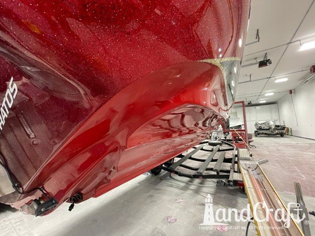 Stratos boat that has had scrapes and gouges repaired in multiple colors of gelcoat and metalflake