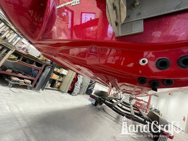 Stratos boat that has had scrapes and gouges repaired in multiple colors of gelcoat and metalflake