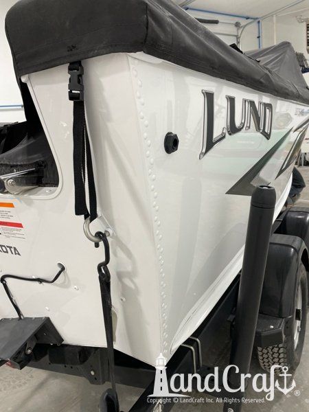 Aluminum Lund boat that has had dent and damage repaired and refinished