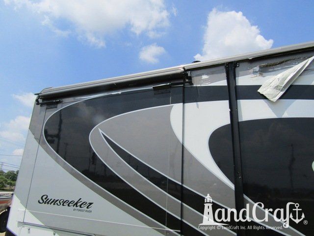 Forest River RV with side damage and tear punctured through due to an accident