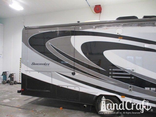 Forest River RV with side damage and tear punctured through due to an accident