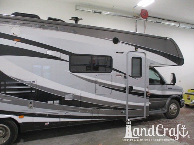 Forest River RV with side damage and tear punctured through due to an accident