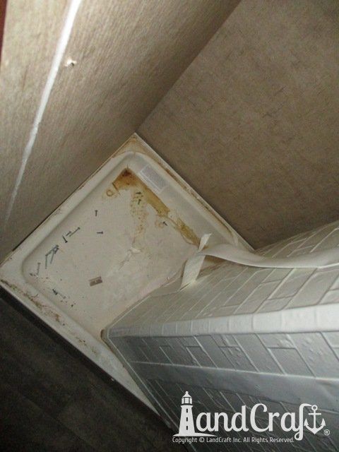 Forest River RV with damage being repaired inside bathroom wall