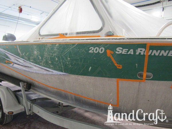 Picture of scratches along entire side and rubrail of an aluminum Hewescraft boat