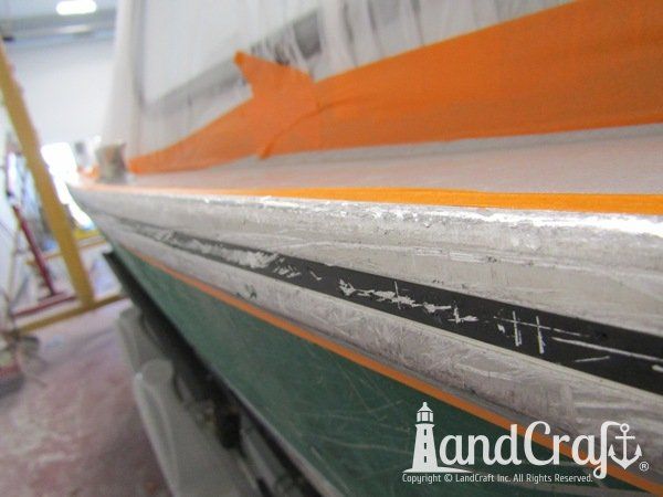 Close up picture of scratches on aluminum rubrail of Hewescraft boat