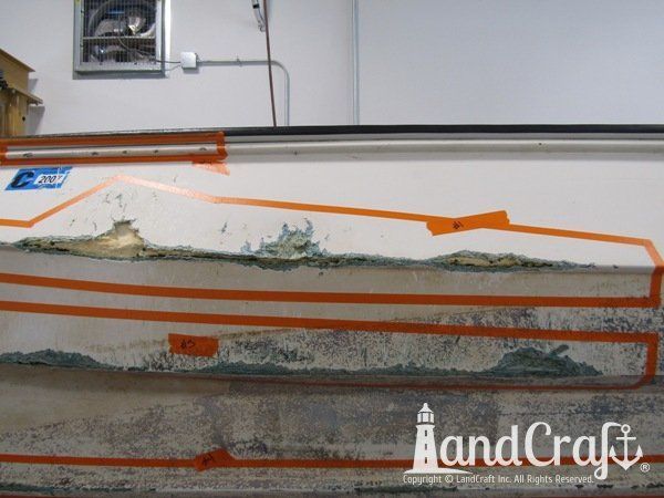 Grounding damage with holes on bottom hull of a fiberglass Boston Whaler boat