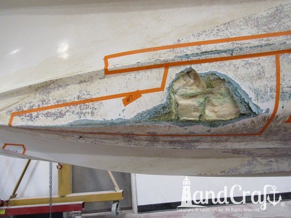 Grounding damage with holes on bottom hull of a fiberglass Boston Whaler boat