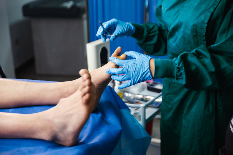 Podiatric care exam with doctor wearing gloves inspecting patient’s foot on medical chair. Podiatric care exam with doctor wearing gloves inspecting patient’s foot on medical chair.