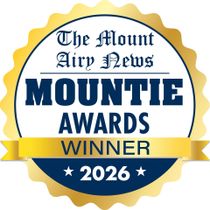 Gold seal reading “The Mount Airy News Mountie Awards Winner 2026” in blue and white.