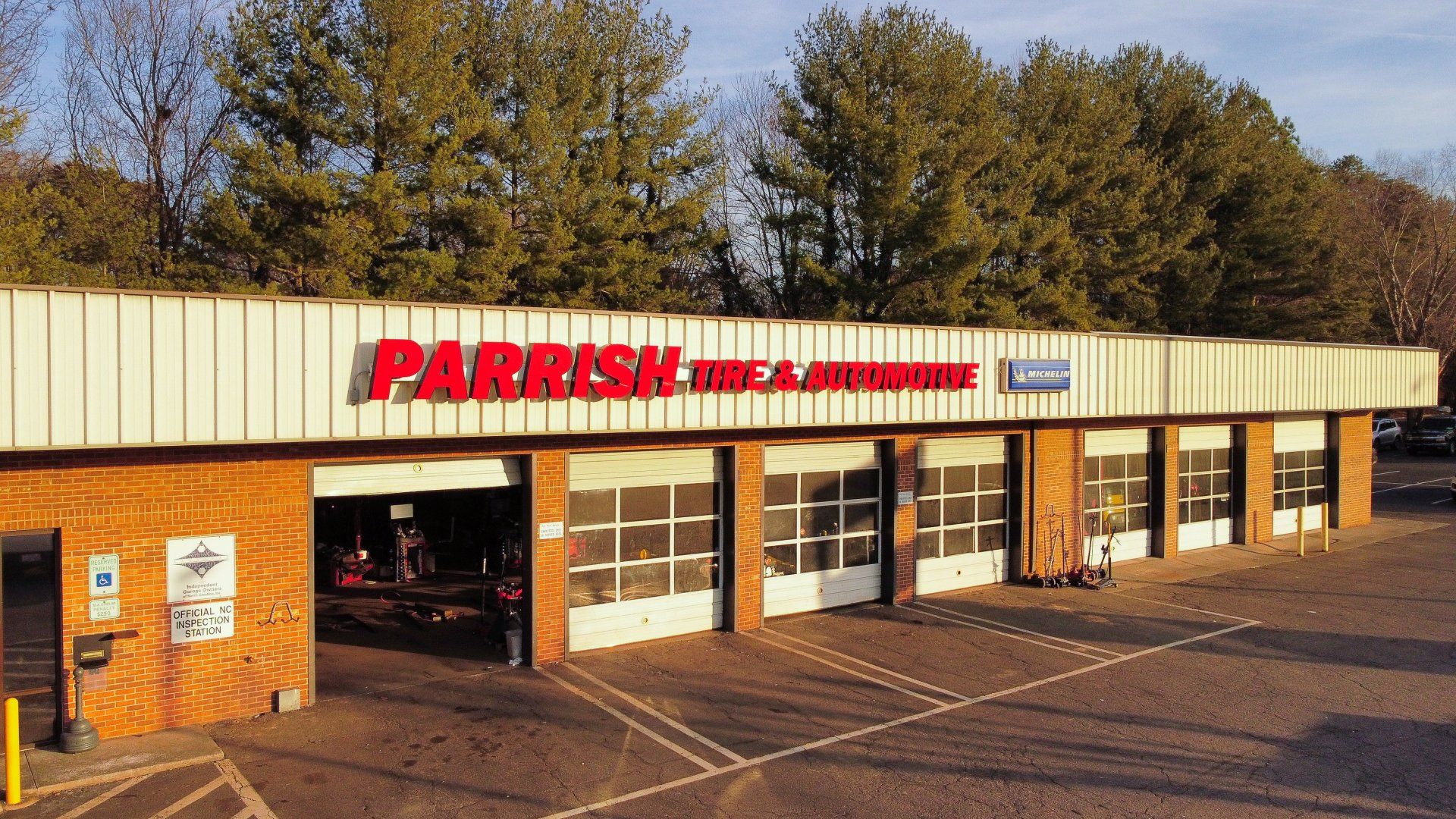 A parrish tire and auto shop is located in a parking lot