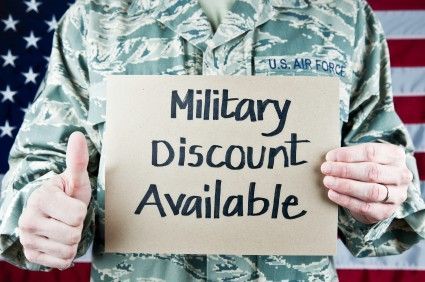 Air Force member in uniform holding a sign that reads 
