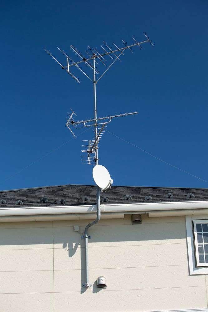 A House With a Lot of Antennas on the Roof — Garrow's TV & Antenna Services in Caloundra West, QLD