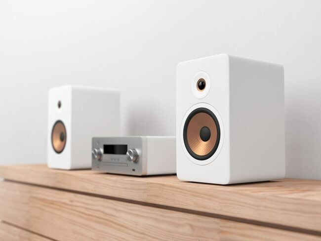 Two White Speakers and a Receiver Are Sitting on a Wooden Shelf — Garrow's TV & Antenna Services in Caloundra West, QLD