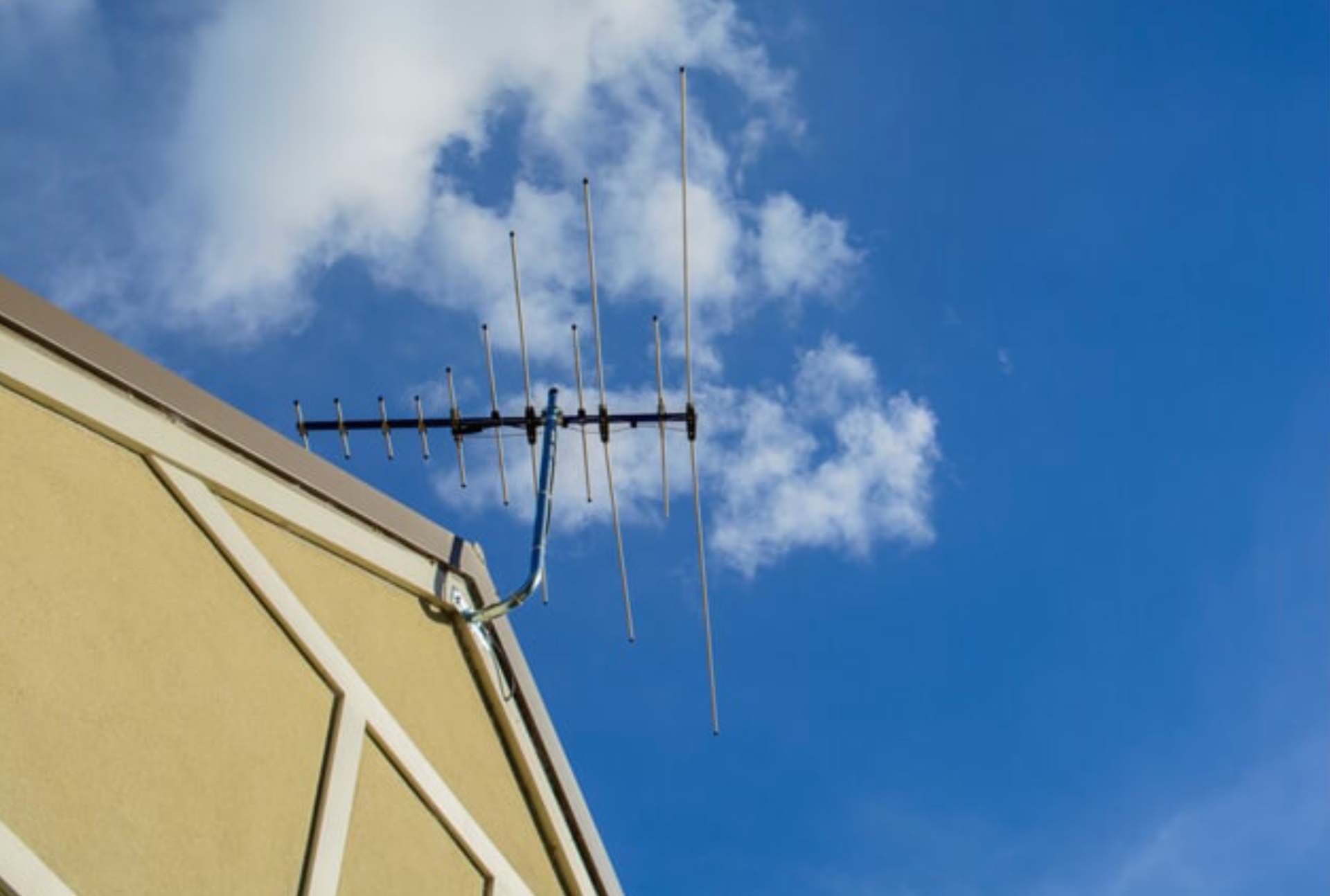 An Antenna is Mounted on the Side of a Building — Garrow's TV & Antenna Services in Sunshine Coast, QLD