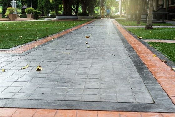 Decorative and stamped concrete hardscaping around the lawn.
