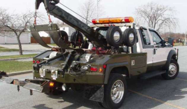 Picture of a white delta towing group truck with emergency lights