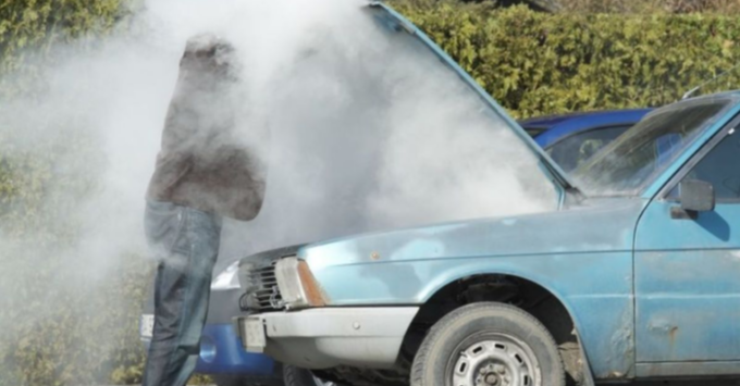 Picture of a over heated car require a tow truck service to to to a mechanic