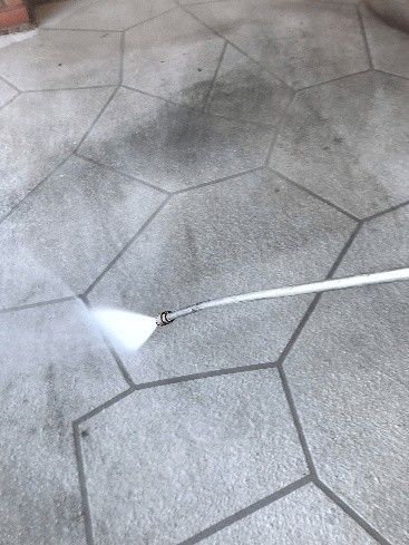 A person is pressure washing a floor.] [Image ID: from their website.
