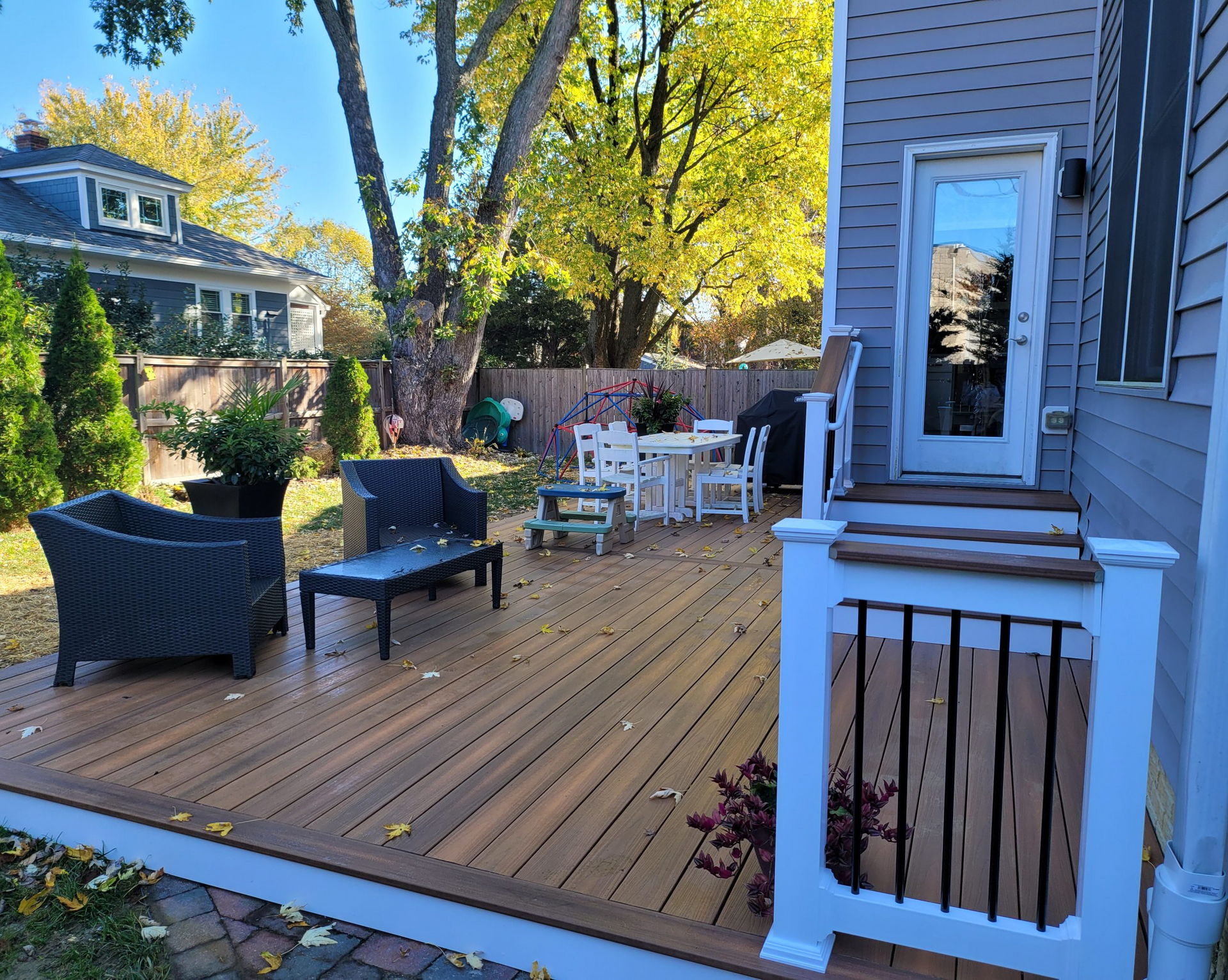A wooden deck with a table and chairs on it