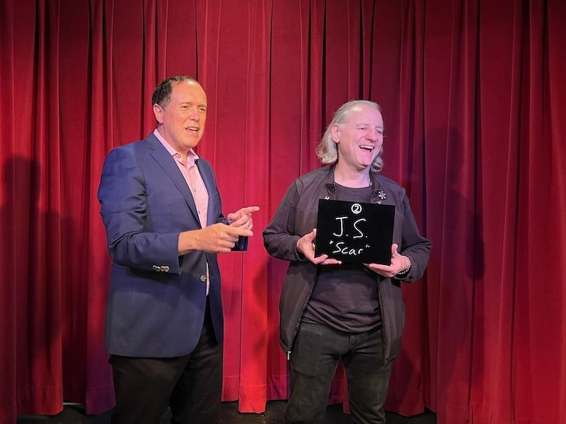 San Francisco corporate magician David Martinez performs on stage with an audience helper