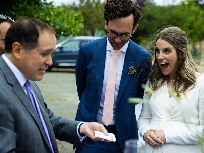 Wedding magician David Martinez performs a trick for a surprise bride and groom at their wedding