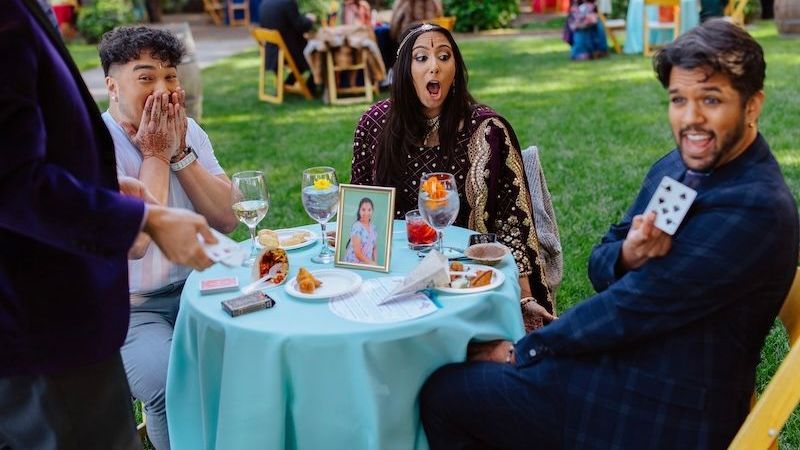 Party magician David Martinez wows guests at an outdoor event.
