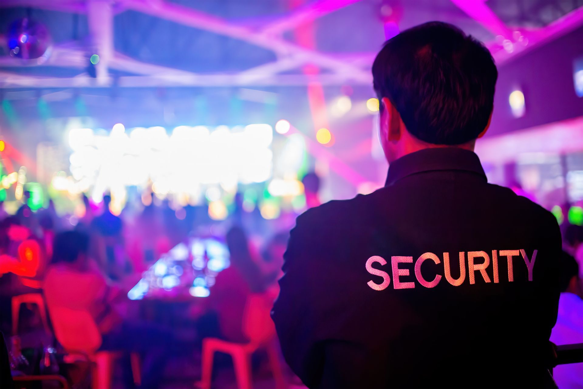 A security guard in a black uniform with 