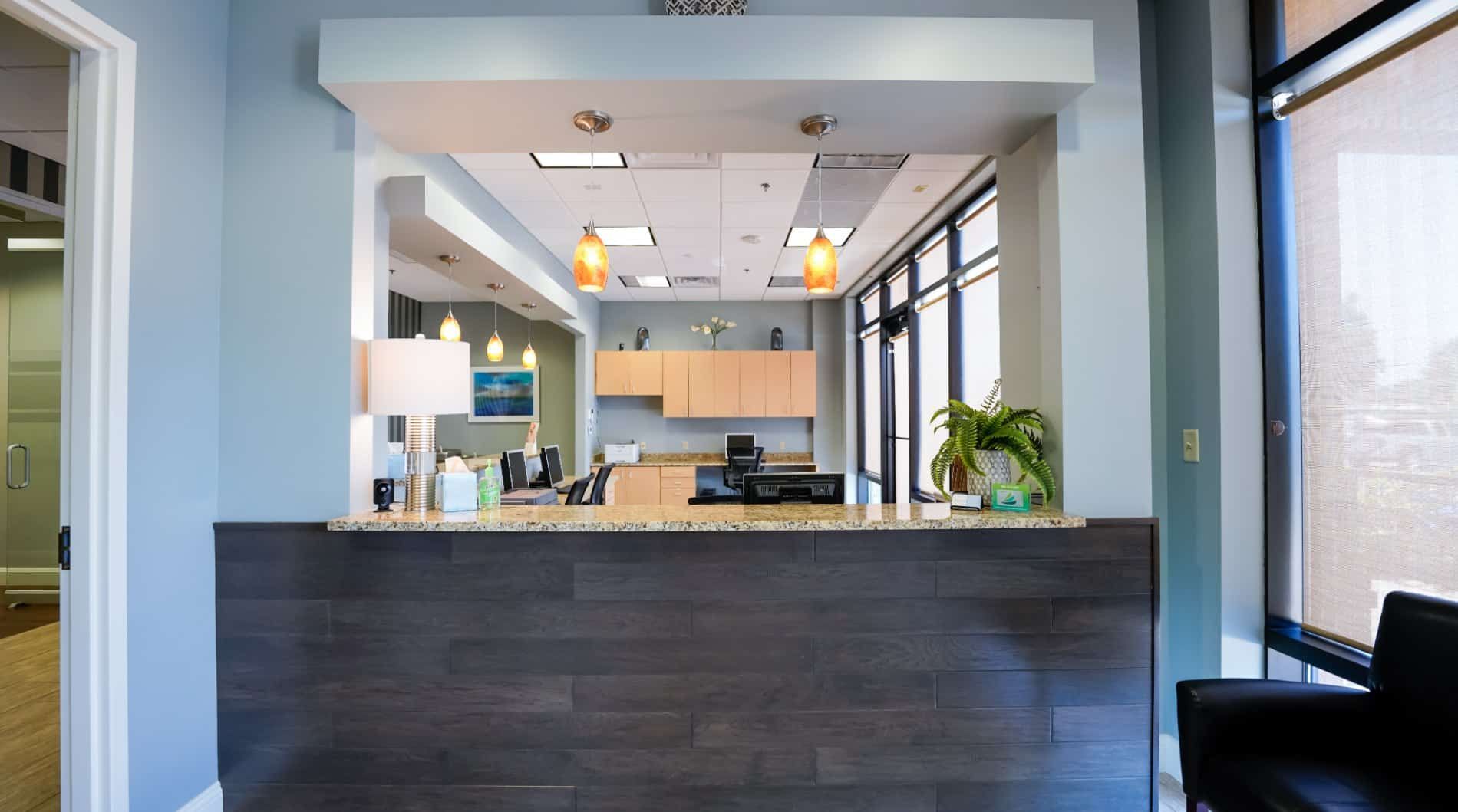 A dental office with a waiting room and a counter.