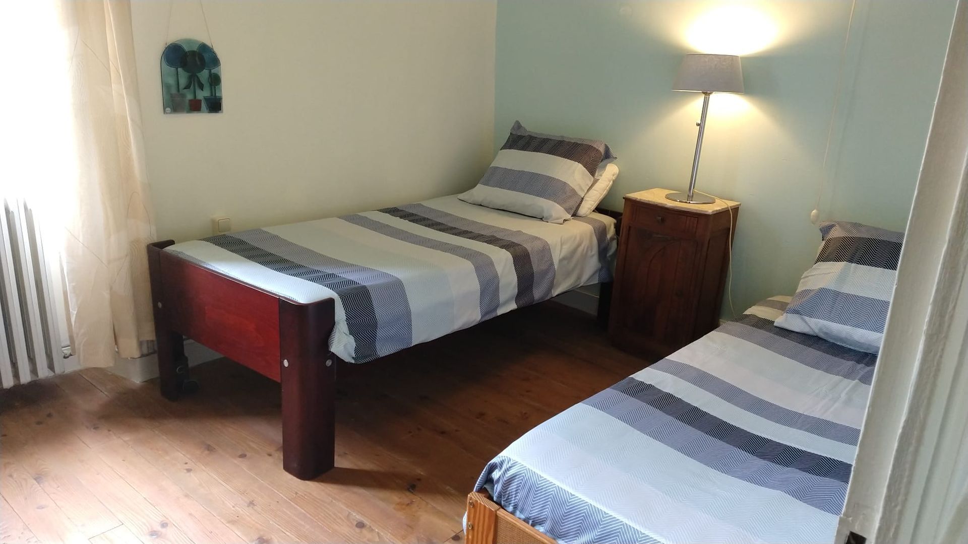 A bedroom with two twin beds and a nightstand