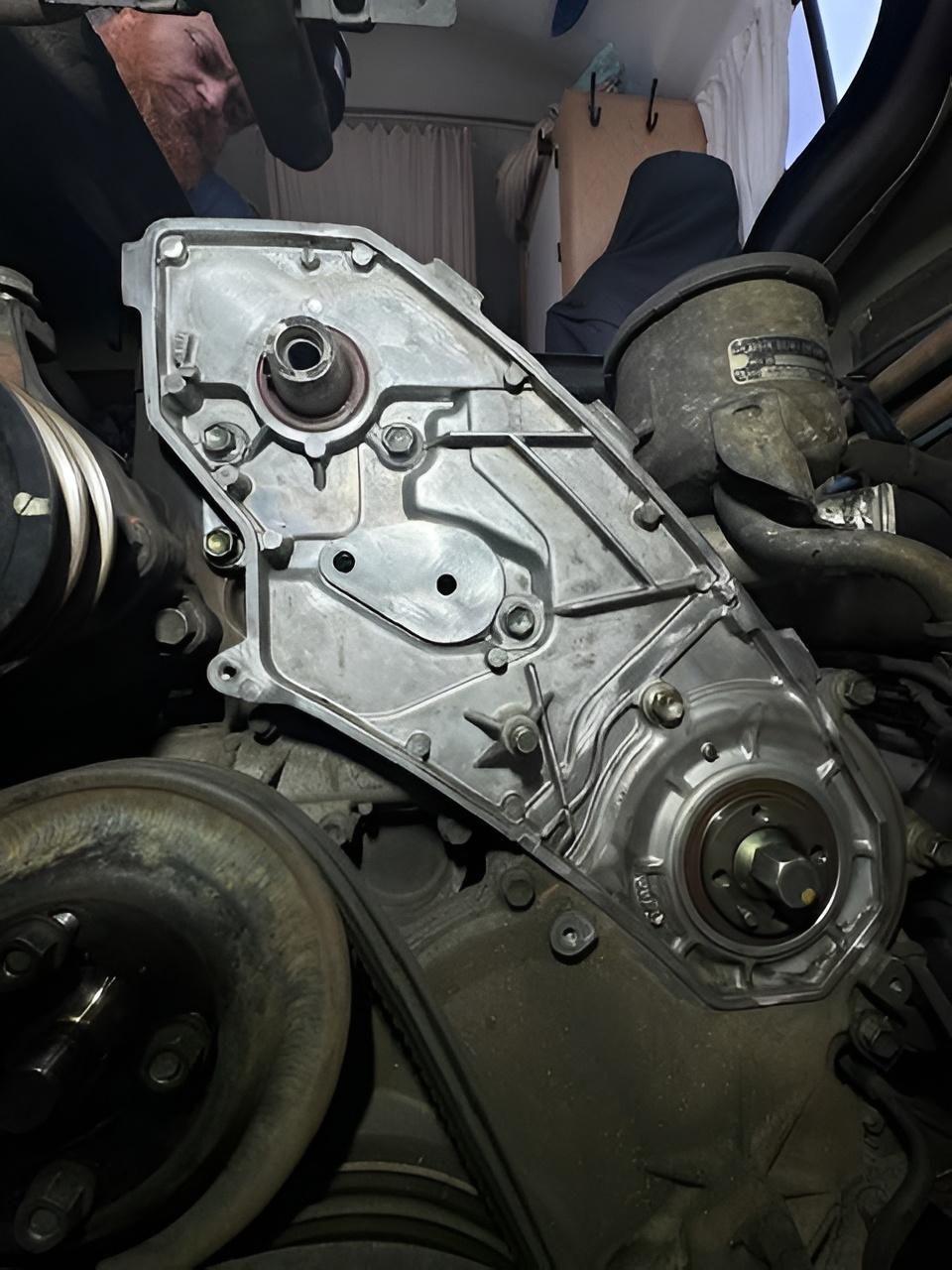 Mechanic in Nowra removing a timing chain cover during an engine repair at Shoalhaven Diesel Tech