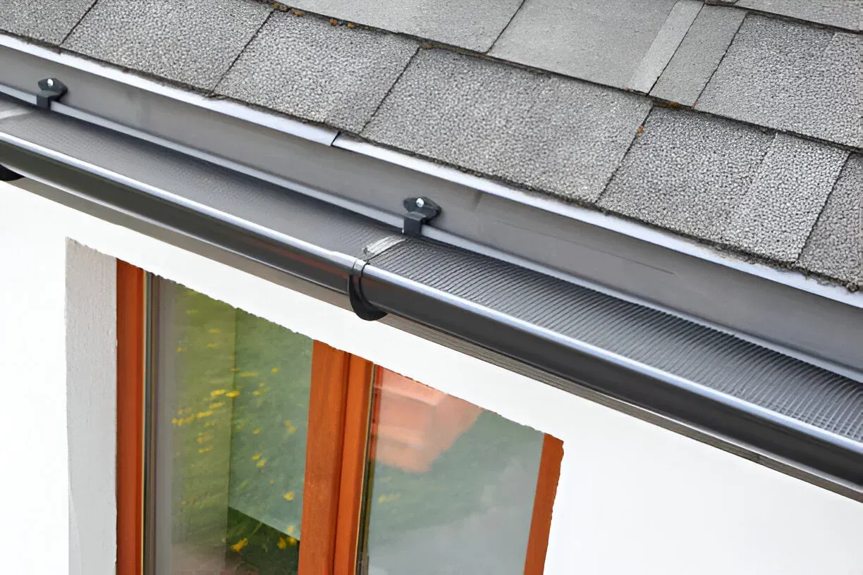 Retractable awning mounted above a window on a house exterior